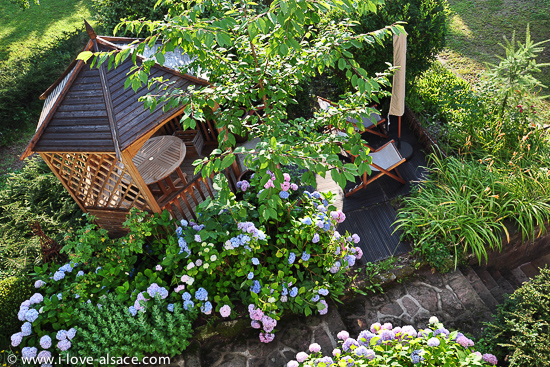 Une maisonnette (avec banc et table pour y manger) et une petite terrasse dans le jardin sont  la disposition des occupants de l'appartement du Randonneur.